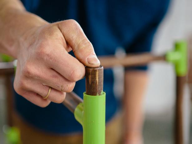 Insert 2" wood dowels into open ends of PVC T's to make a coffee table.