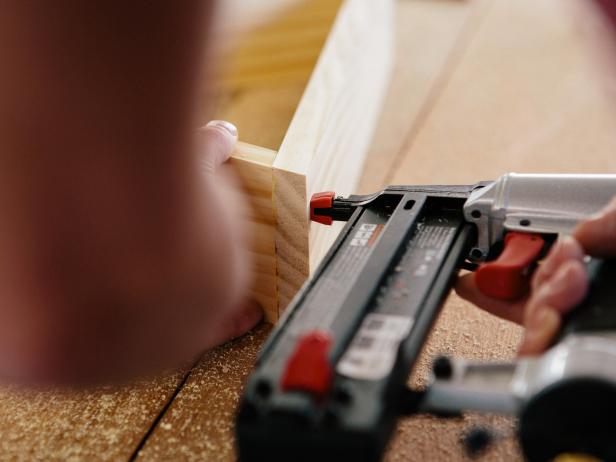 Nail wood pieces together to make a triangle shelf.