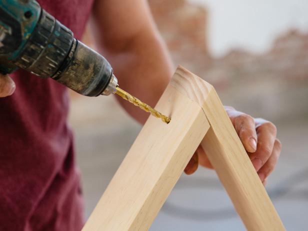 Drill holes at the top of wood shelf to make a loop for hanging.