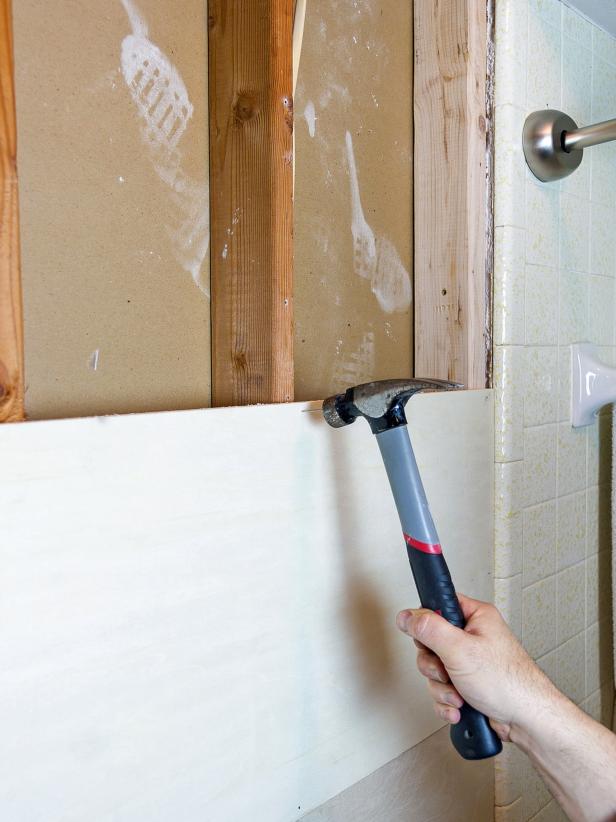 Attach the strips to the wall starting at the floor and work your way up to the ceiling. Use finishing nails to secure the strips to the studs near the top and bottom of the strips so the nail heads will be covered by the strips of trim later.