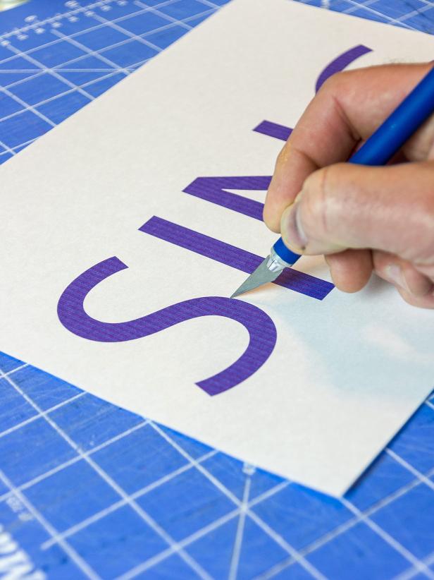 Print the word or phrase of your choosing on paper and then tape to removable, adhesive shelf paper. Cut out the word with a craft knife.