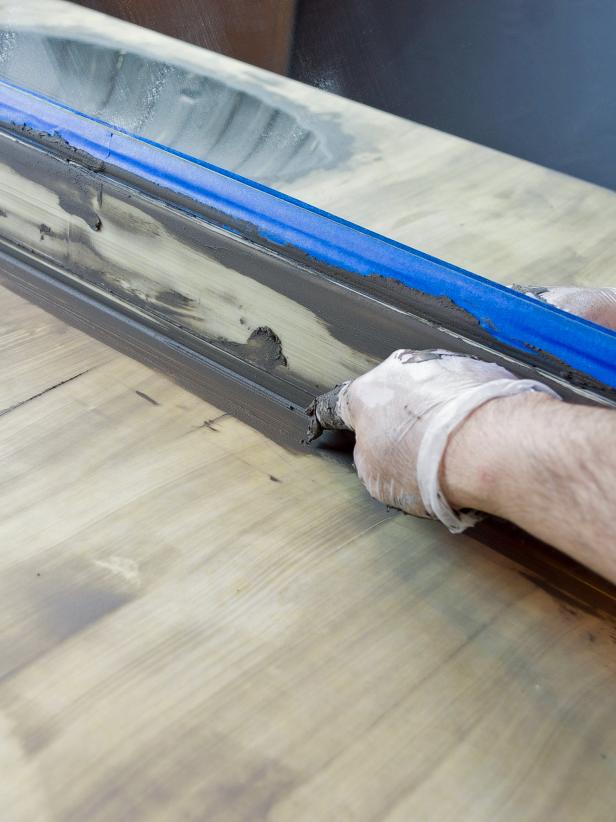 Use your finger or thumb to apply a coat into the corners where the countertop meets the backsplash.