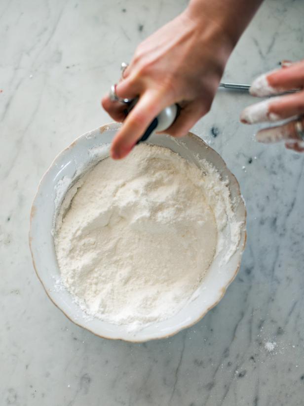 Spray dry mixture with water in a spritzer or spray bottle. Mix ingredients with on hand as water is sprayed with the other. Add water slowly, to avoid adding to much. Enough water has been added when mixture will keep its shape when squeezed.
