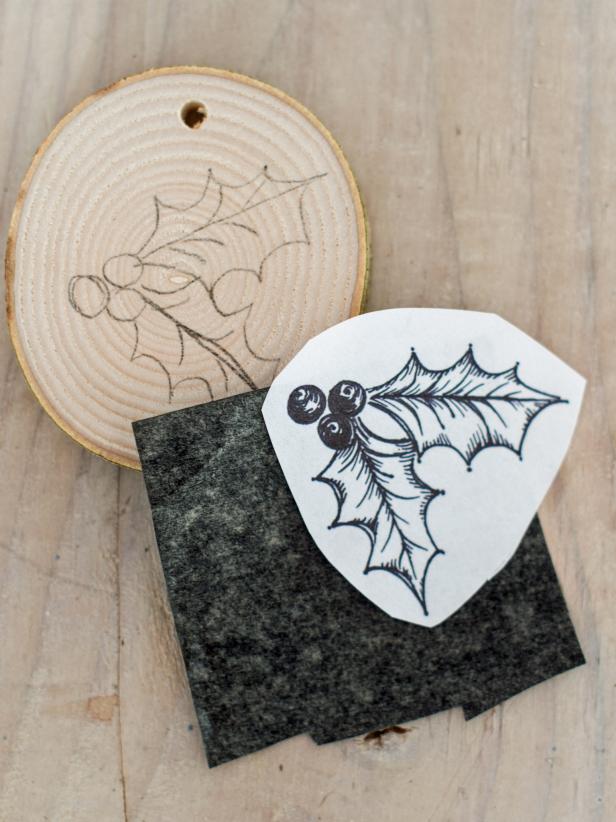 Print text and images from a computer sized to fit wood slices. Cut out each letter and image with scissors. Cut a piece of transfer paper to size as well. Once piece of transfer paper can be used for wood slices. Place transfer paper directly on wood slice and top with printed letter or image. Trace with a dull pencil or closed pen/pen cap. Repeat with other wood slices.