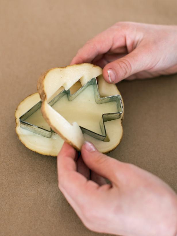 Cut around the cookie cuter about 1/2" depth, so part of the potato inside the cookie cutter will protrude 1/2". Remove cut portion of the potato around cookie cutter. Remove cookie cutter from potato.