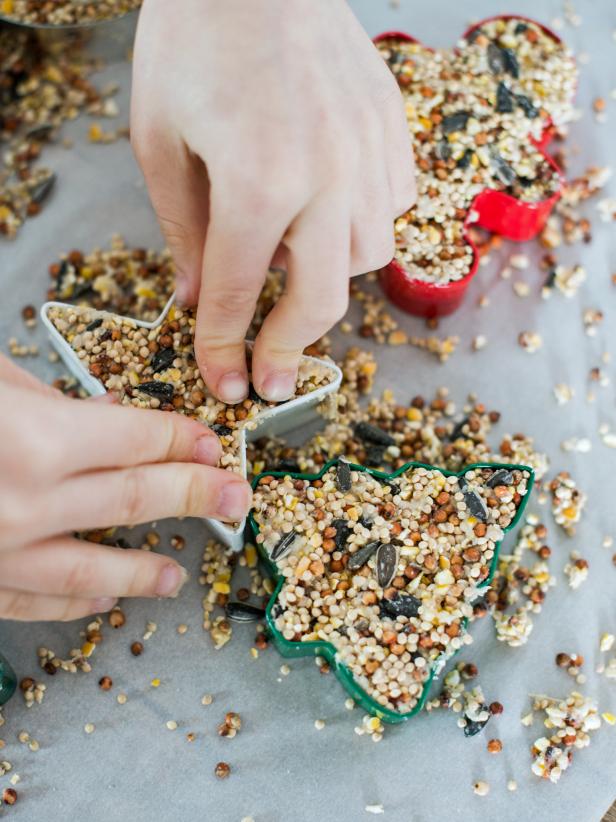 Allow birdseed ornaments to dry uncovered, at room temperature until hardened (several hours or overnight.) Gently push out the molds/cookie cutters and remove straws.