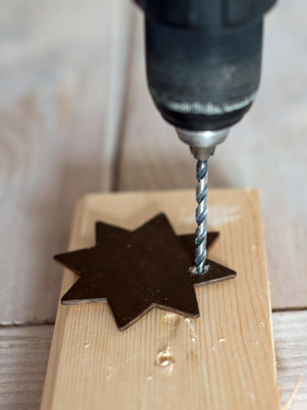Drill a single hole at the top of each painted ornament with an 1/8" drill bit to thread a string or ribbon through.