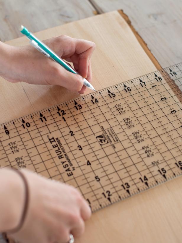 Use a ruler and pencil to draw a tic-tac-toe board on rectangular wood slice. A clear quilting ruler is perfect for getting a 90-degree angle and even spacing.