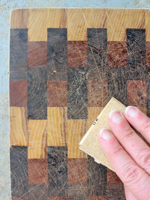 Working from coarse- to fine-grit, thoroughly sand cutting board's surface.