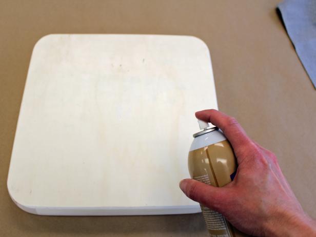 Evenly coat the underside of the tray with spray adhesive.