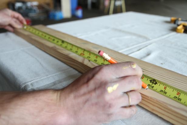 Measure and mark a wood plank at 24&quot; to make a wood centerpiece.