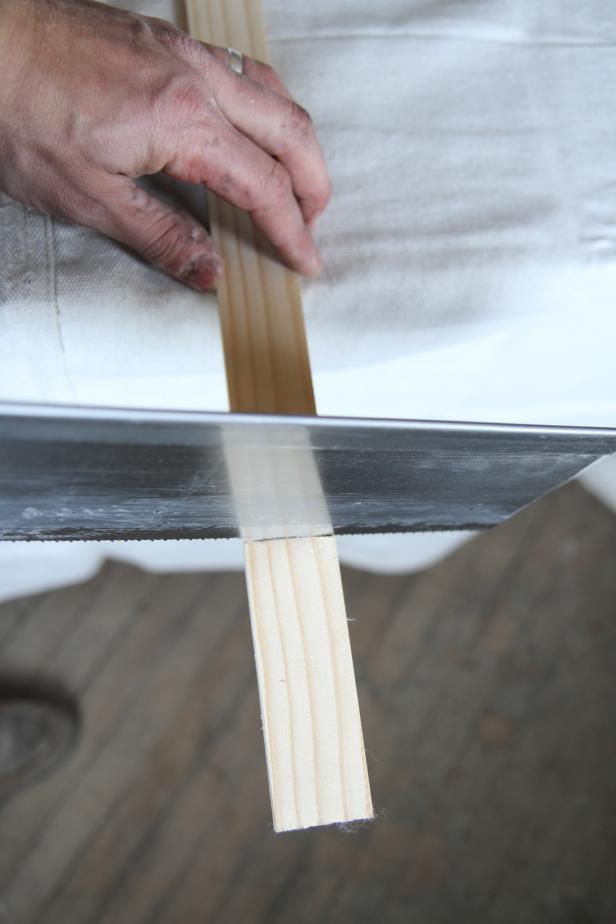 Use a hand saw to cut a paint stick at 4".