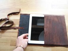 Dan Faires placing iPad in leather case.