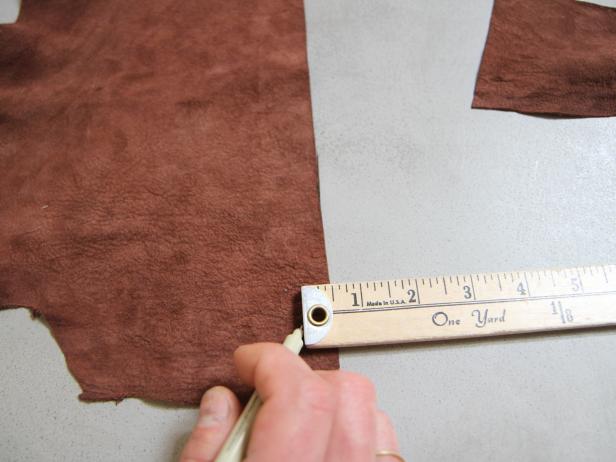 Measure and mark a long thin leather strip at 1/2" wide by about 30" long.