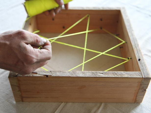 Pull the string across to another carpet tack and wrap. Repeat until all of the carpet tacks have been wrapped with twine.