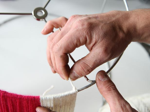 Tie a knot when you're finished wrapping the second yarn color around the lampshade.