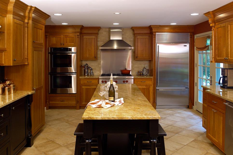 Traditional Brown Kitchen With Black Island & Neutral Countertops