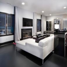Photos | HGTV - Modern Black and White Living Room Featuring White Leather Sectional, Black  Matte Floor and White Curtains With Black Trim