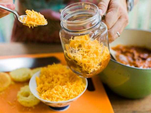 Place cornbread in the bottom of the jar, then add ½ cup chili and ¼ cup shredded cheese.