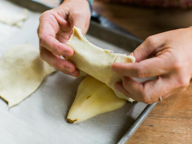 Place pears cut side down on baking sheet with parchment paper. Cut the thawed sheet of puff pastry into 6 rectangles.