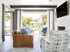 Neutral Living Room Spills Outdoors Through Retractable Windows