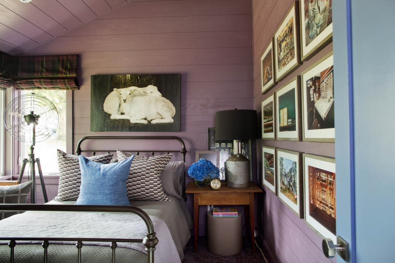Plum painted custom millwork with blue tie-ins and traditional furniture provide a unique and inviting farmhouse style room to make guests feel comfortable and at home. “Purple is a really hard color to work with, but plum is purple with just enough brown in it to make it a little more on the new neutral side,” says interior designer Brian Patrick Flynn.