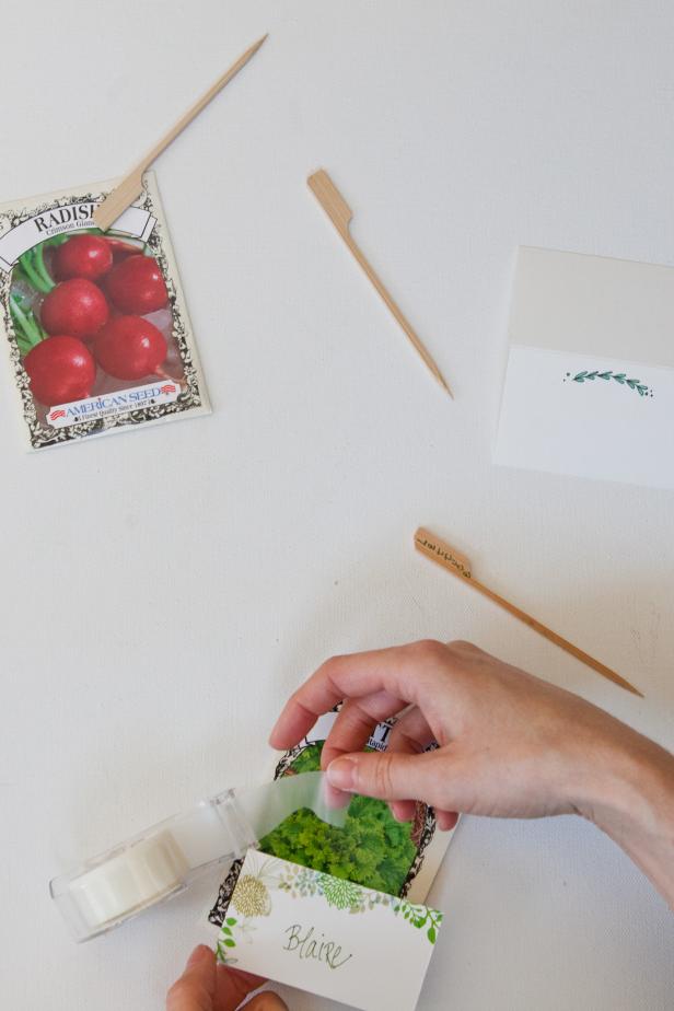 Tape guests' individual name cards onto seed packet.