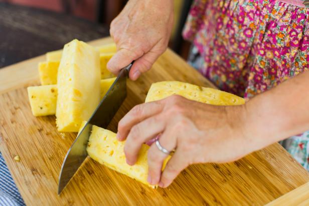 Cut the pineapple into several long wedges, then cut the wedges into ¾ inch slices.