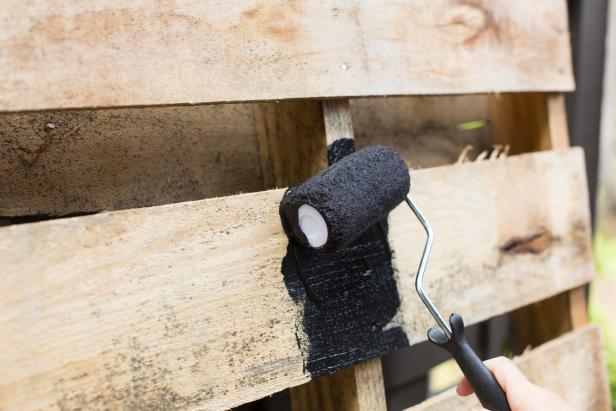 Using a roller, paint the flat boards in a vertical direction and let dry.
