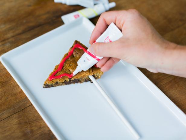 Decorate by outlining the pennant shape with a thin line of icing. Alternate team colors for a festive presentation.