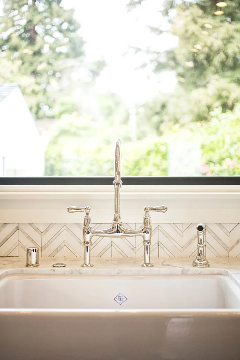 Bridge Faucet in Polished Nickel Against Chevron Tile Backsplash