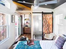 Small White Eclectic Bedroom With Copper Panel Door & Storage Rack