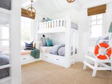 White Coastal Kids' Room With Four White Bunk Beds and Lifeguard Chair