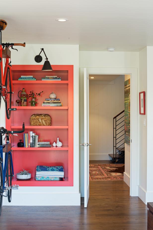 Vibrant Red Bookshelf Pops in Crisp White Bedroom Vibrant Red Bookshelf Pops in Crisp White Bedroom