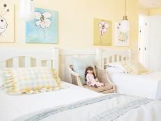 Girls' Light Yellow Bedroom With White Beds and Yellow Plaid Pillows