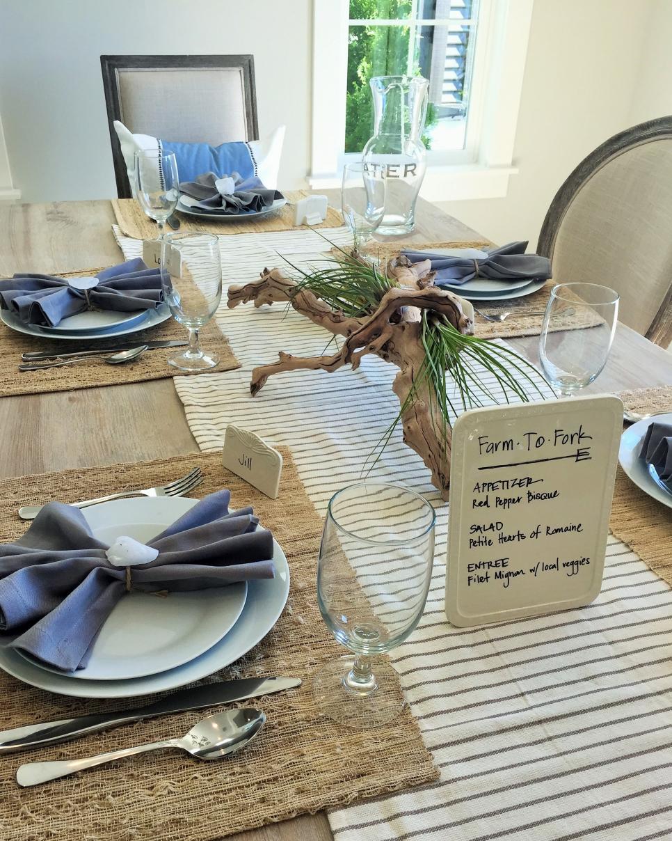 Coastal Table Setting With Nature-Inspired Touches Table Setting With Driftwood Centerpiece and Blue Napkins
