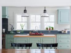 Cottage Kitchen Has Mint-Green Cabinetry and Wood-Topped Island