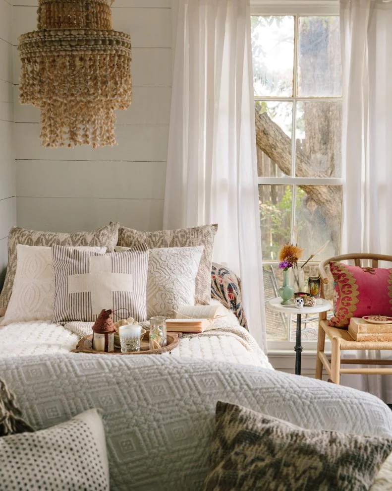 White Bedding, Tan Chandelier & Sheer White Curtains in White Bedroom