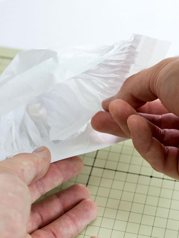 Loop the other end of the pleated paper over and attach with tape so the outside edge is lined up with the edge of the card stock. The inside edge will overlap the other side of the pleated paper in the middle of the card stock.