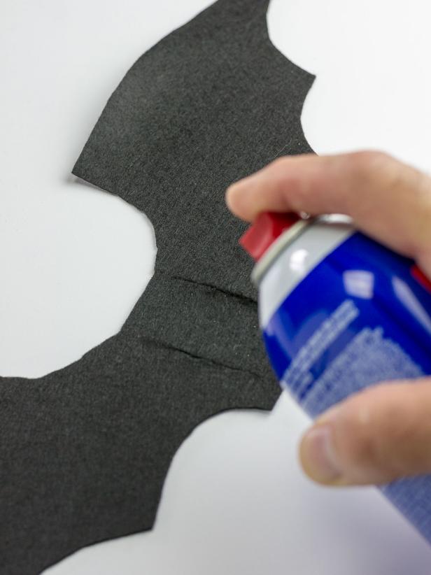 Using a fabric tape measure, measure around your pet’s chest behind their front legs. Next, cut a strip of black felt 1-1/2" wide and 2" longer than the measurement of your pet's chest. Lay the wings with the cut slits on a flat surface and spray with adhesive.
