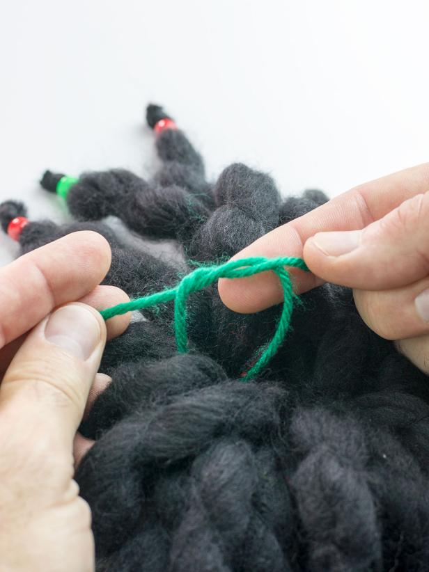 Knot the yarn on the inside of the hat.