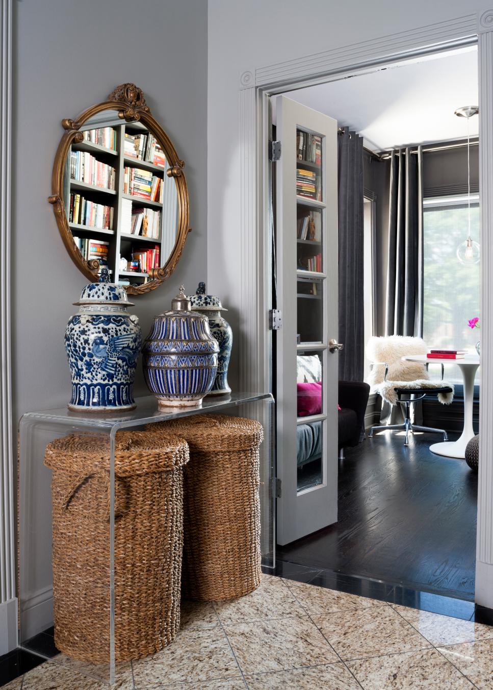 Mediterranean Hall Decor Featuring Tall Wicker Baksets Under a Clear Plastic Table With Decorative Blue Vases Hallway Mediterranean Decoration