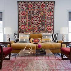 Eclectic Living Room With Mustard Yellow Sofa, Patterned Wall Tapestry and Mixed Decorative Throw Pillows