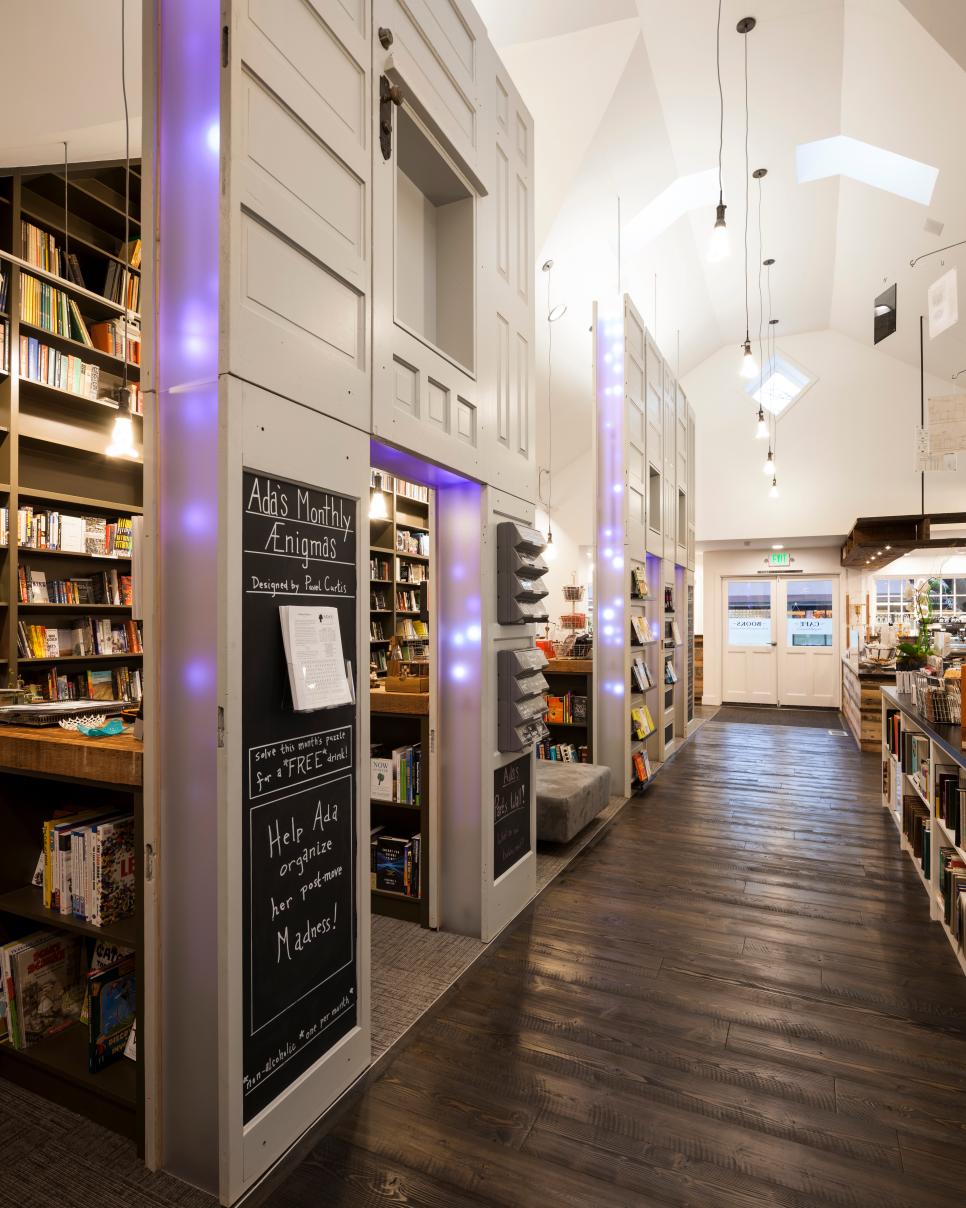 Salvaged Doors Create Separation Wall in Creative Cafe Contemporary White Cafe With Bookstore Section