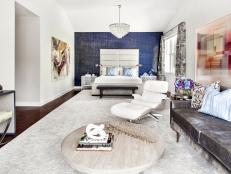 Contemporary Master Bedroom With Blue Accent Wall and Seating Area