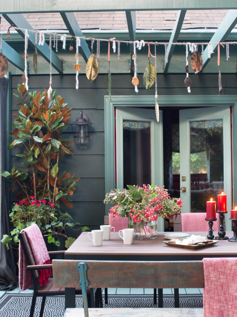 Fall-Inspired Garland Hanging Over Outdoor Dining Area