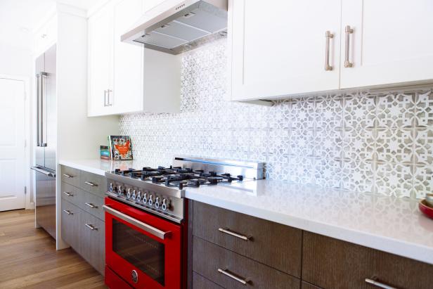 Galley Kitchen Features Contrasting Upper & Lower Cabinets and Bright Red Oven
