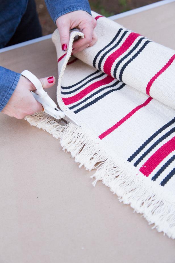 Using sharp scissors, remove the fringe from edges of the rug.