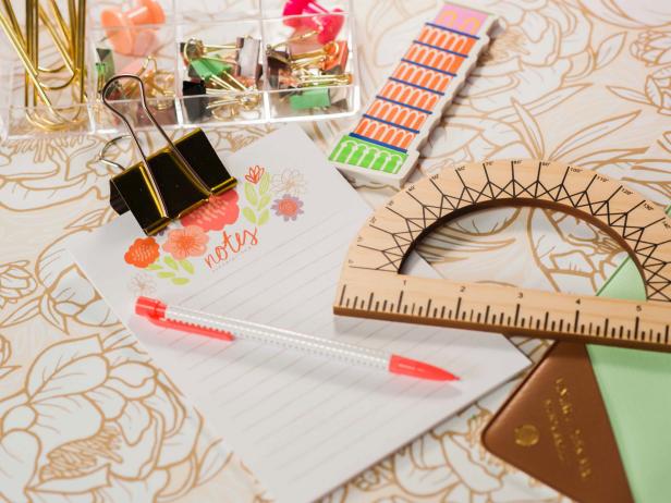 Close Up Of Dorm Room Desk Accessories on White and Gold Peony Wallpaper Covered Desk Top Close Up Of Dorm Room Desk Accessories on White and Gold Peony Wallpaper Covered Desk Top