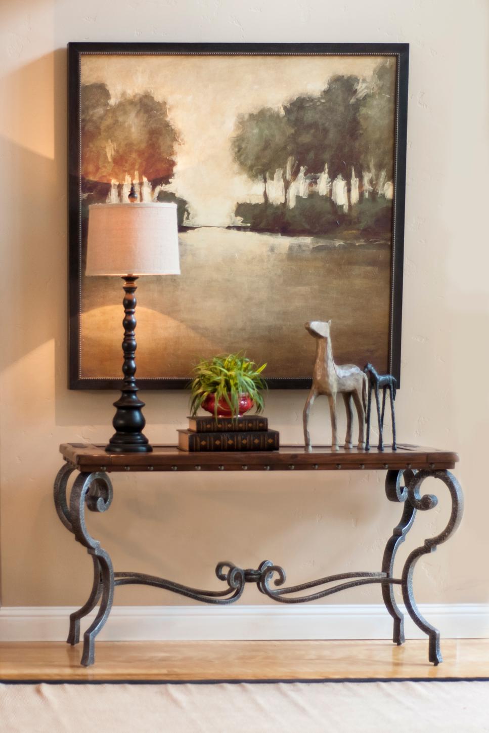 Watercolor Painting Above Elegant Side Table Painting of Trees Hung Above Wood and Metal Table